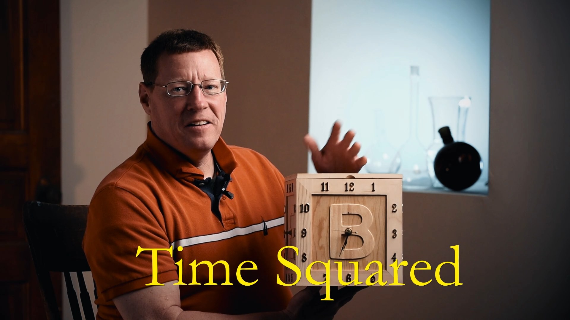 Mark Valentine, holding clock invention