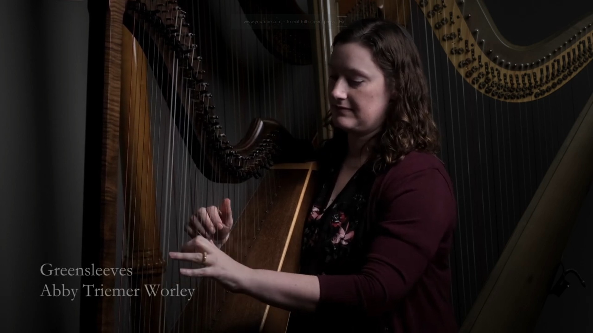 Abby Triemer Worley playing a harp